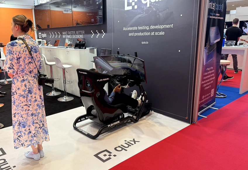 Visitor interaction with ESBAU booth technology during a product demonstration at a trade show