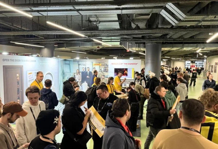Small booth overloaded with furniture displays and meeting areas