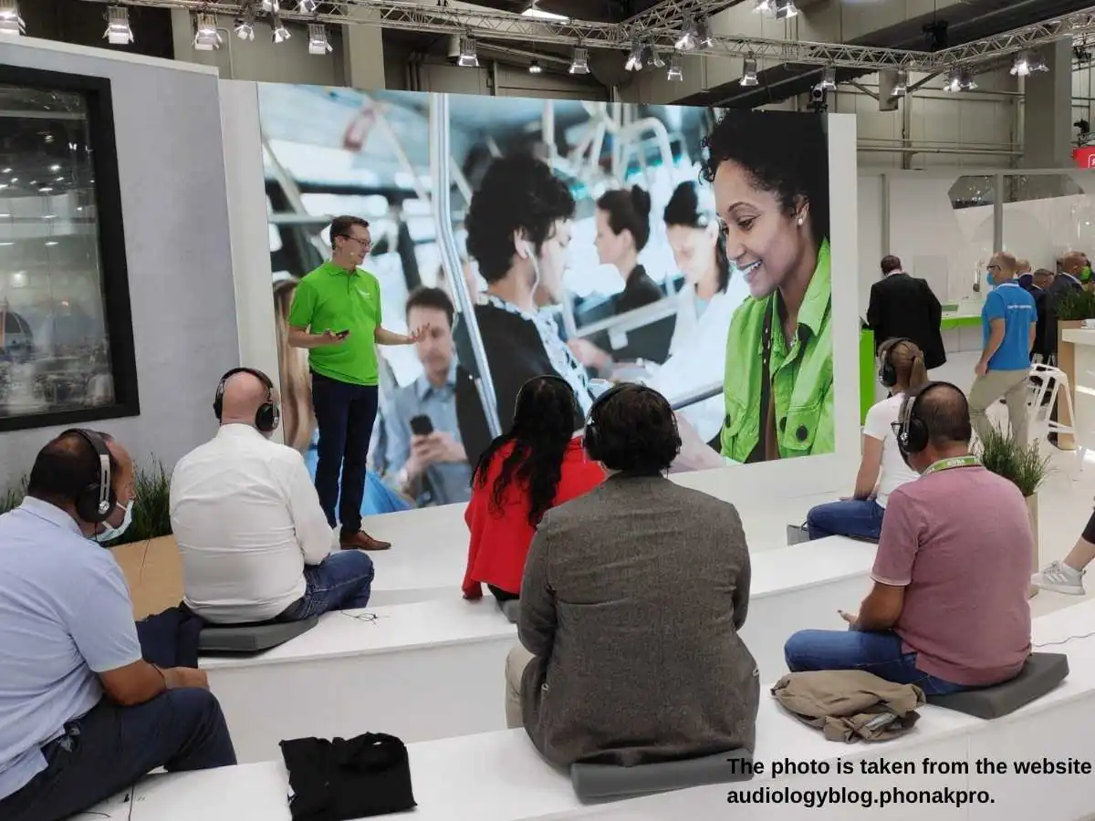 Exhibition stand at 70th International Congress of Hearing Aid Acousticians  2026 in Nuremberg with consultation zone and hearing device displays