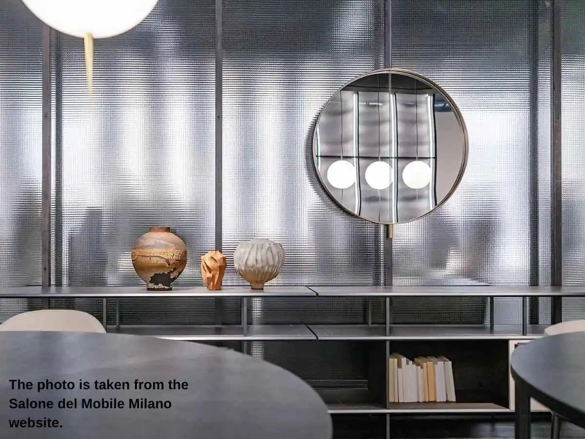 International Furniture Fair Milano  2027 in Milan stand with meeting area and textile display at Fiera Milano