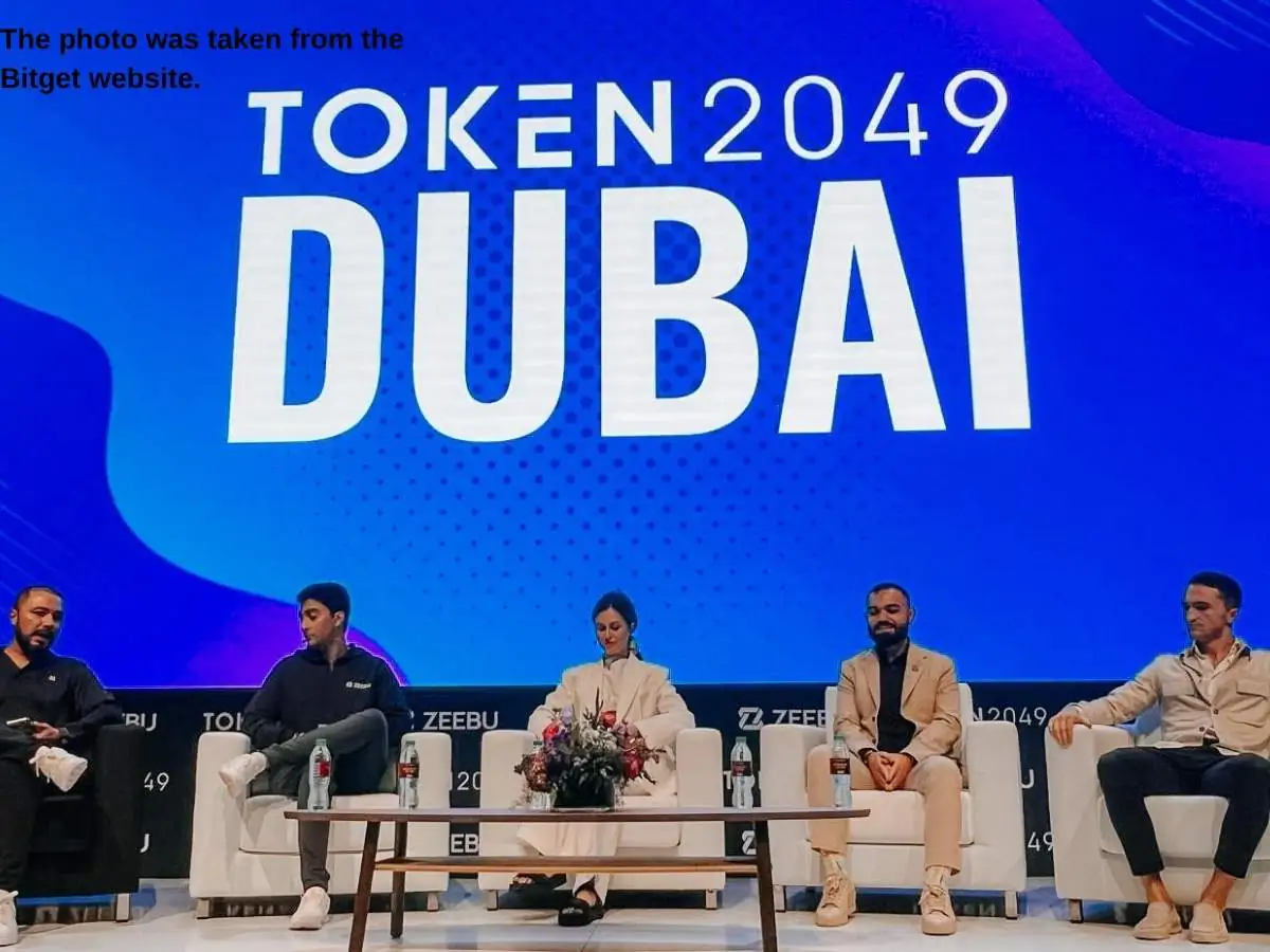 TOKEN2049 Dubai  2027 exhibition stand in Dubai at Madinat Jumeirah Conference Events Centre with demo pods and meeting area